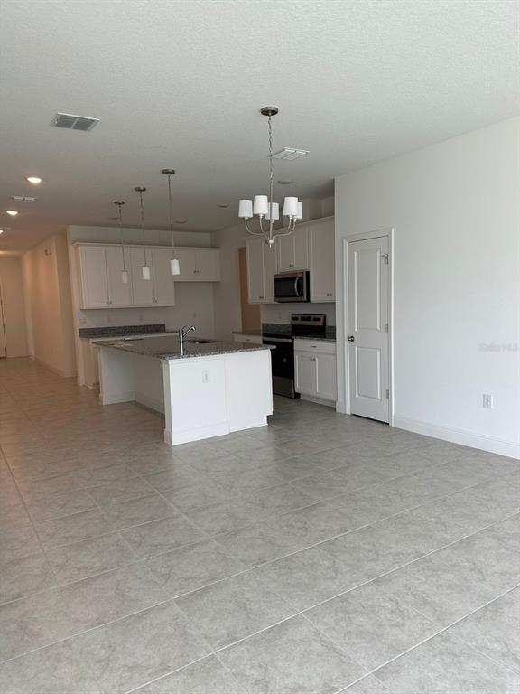 19044 Blueleaf Street Orlando, FL 32827 - Photo 7 of 42 a kitchen with a sink and dishwasher a kitchen island with wooden floor