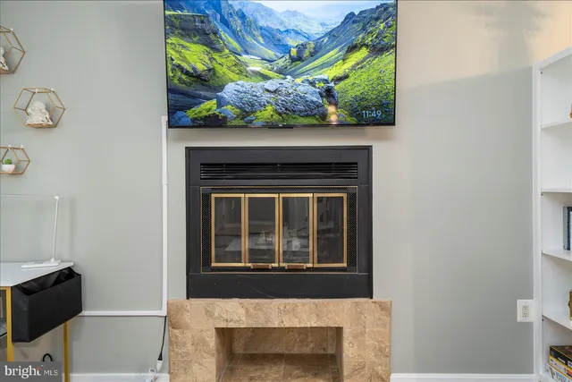 a living room with a fireplace and a flat screen tv
