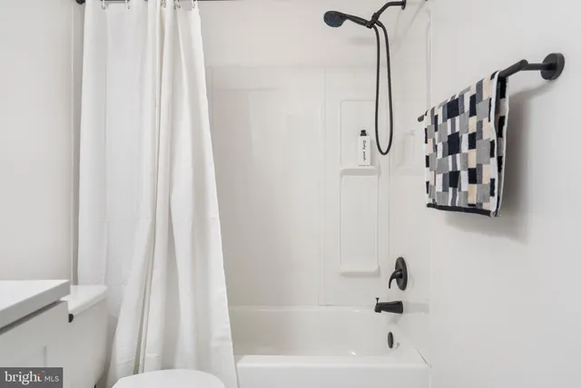 a bathroom with a bathtub and shower