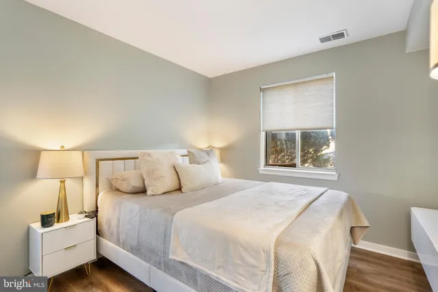 a bedroom with a bed and a lamp