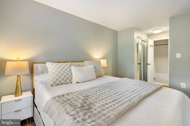 a bedroom with a bed and a night lamp