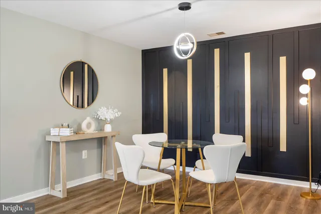 a dining room with furniture and mirror