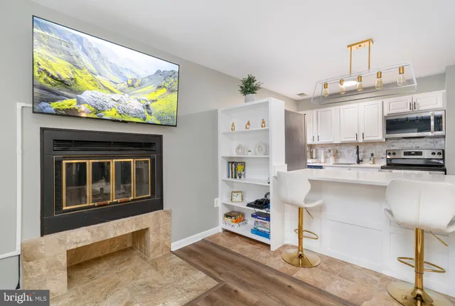 a kitchen with stainless steel appliances kitchen island granite countertop a refrigerator stove and microwave