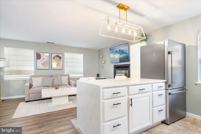 a living room with furniture a fireplace and a chandelier