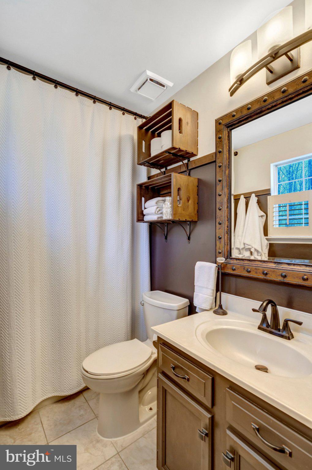 8585 Short Street Manassas, VA 20112 - Photo 18 of 31 a bathroom with a sink a toilet and a mirror