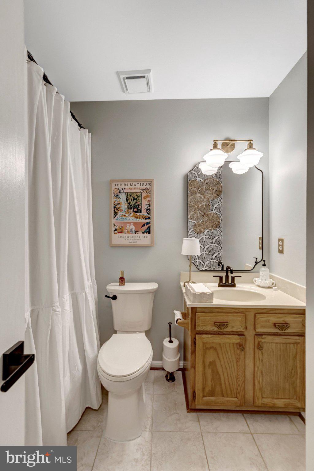8585 Short Street Manassas, VA 20112 - Photo 23 of 31 a bathroom with a toilet a sink and a mirror