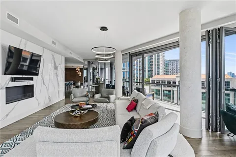 a large kitchen with lots of counter top space a sink stainless steel appliances and cabinets