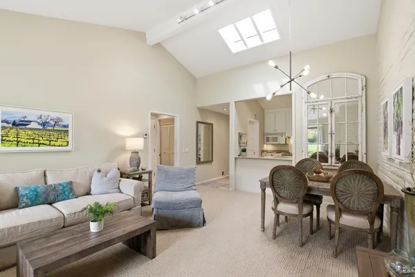 a living room with furniture and a chandelier
