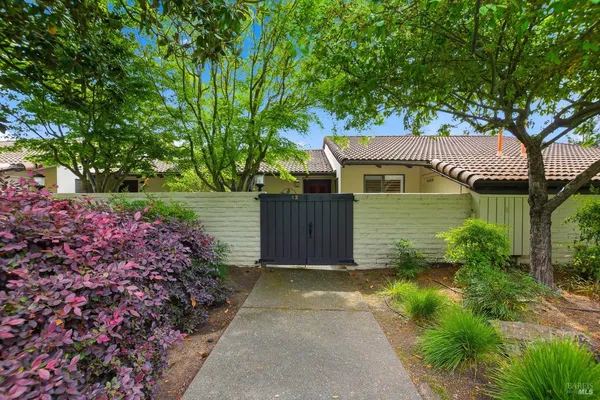 a front view of a house with a garden