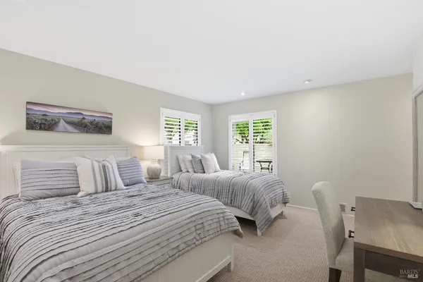 a bedroom with a bed a table and chair