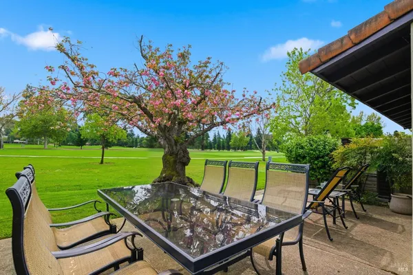 a view of a chairs and table in the garden