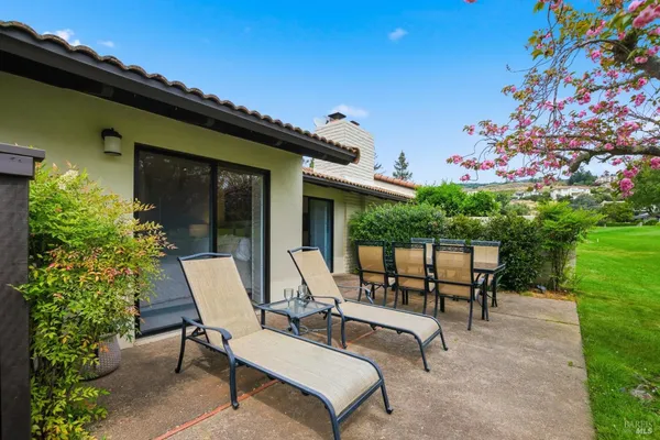 a view of a patio with table and chairs and potted plants