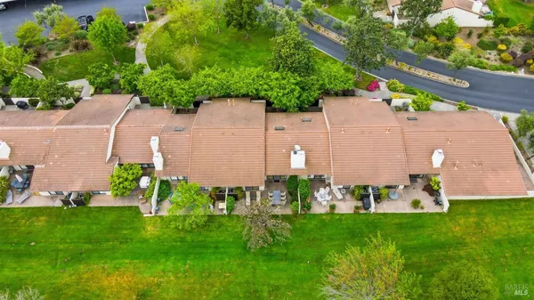 an aerial view of a house with a yard