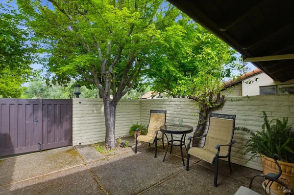 a backyard of a house with table and chairs