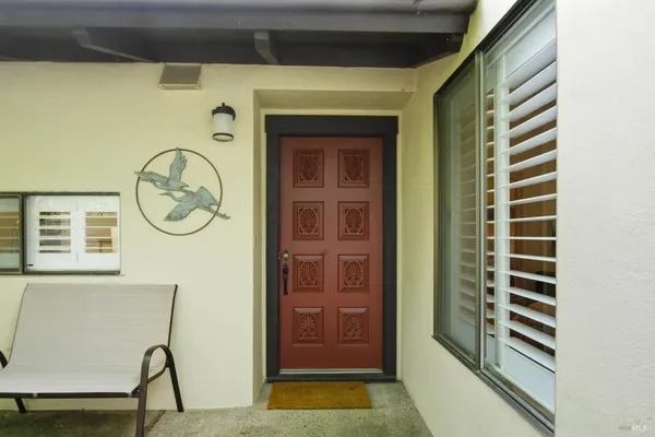 a view of a hallway with entryway wooden floor and front door