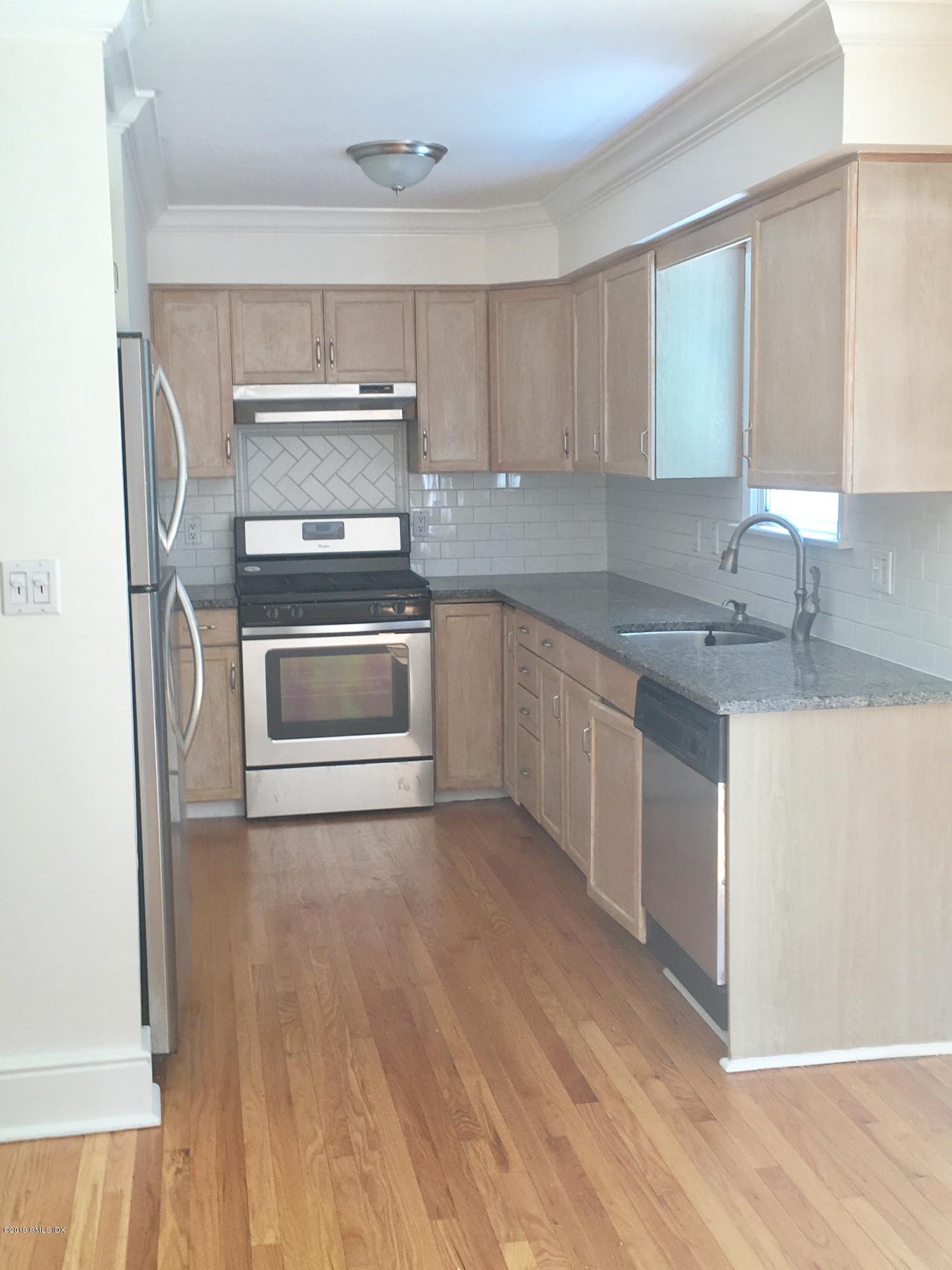 16 Ritch Avenue, Unit B Greenwich, CT 06830 - Photo 6 of 12 a kitchen with a sink stove and cabinets