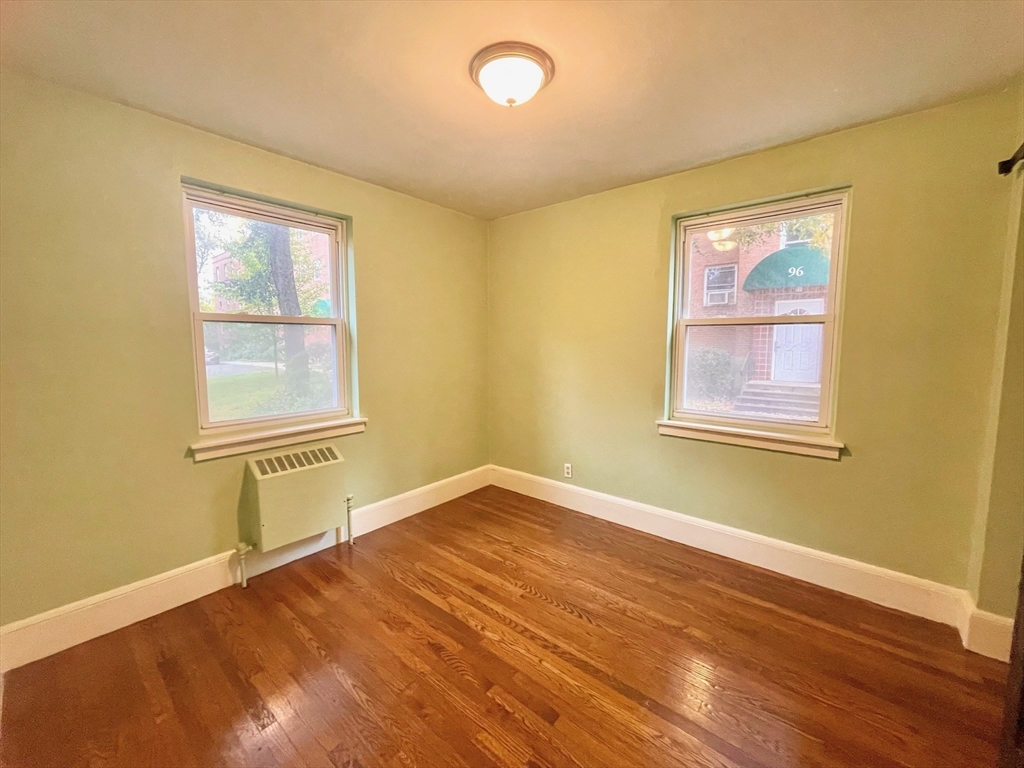 1 O'Leary Way, Unit 91 Boston, MA 02130 - Photo 9 of 12 a view of an empty room with wooden floor and a window