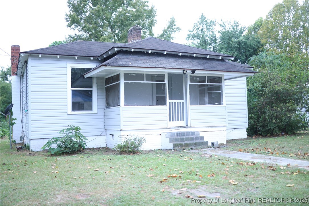64 Beck Street Red Springs, NC 28377 - Photo 2 of 10 a front view of a house with garden