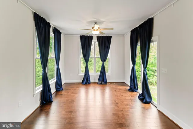 wooden floor in an empty room with windows