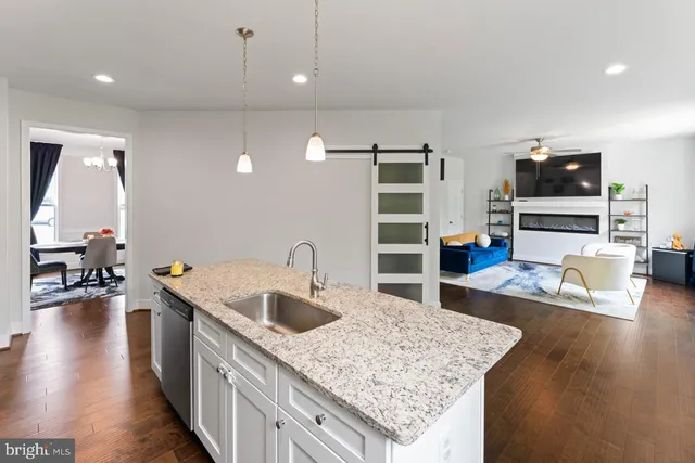 a kitchen with sink refrigerator and microwave