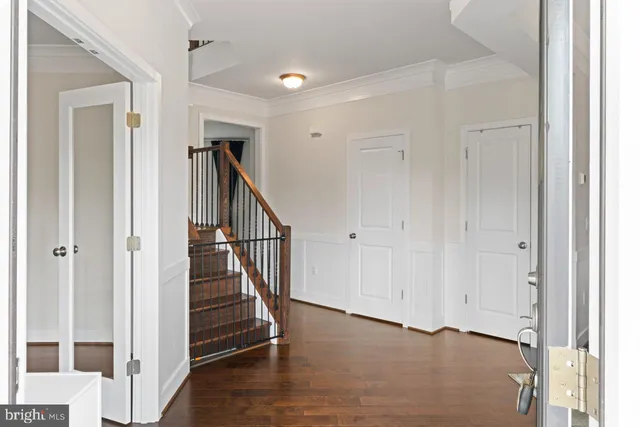 a view of a hallway with entryway with wooden floor