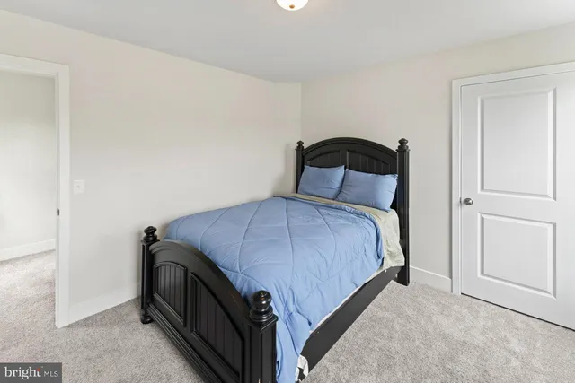 a bedroom with a bed and a mirror