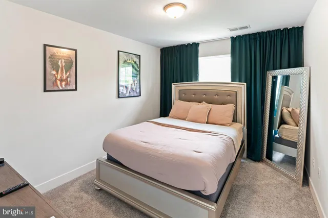 a bedroom with a bed and a painting