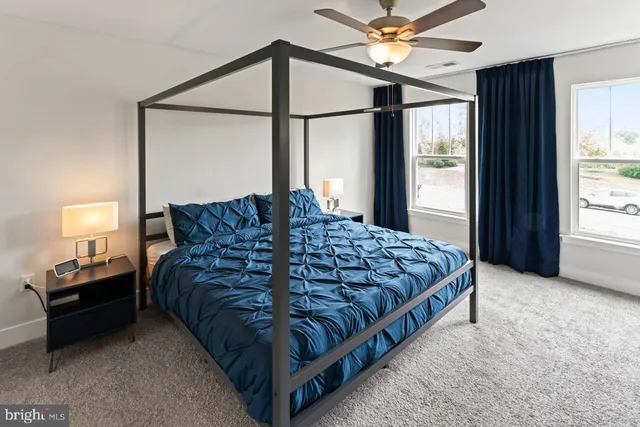 a bedroom with a bed next to a window