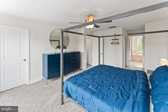 a bedroom with a bed and a dresser