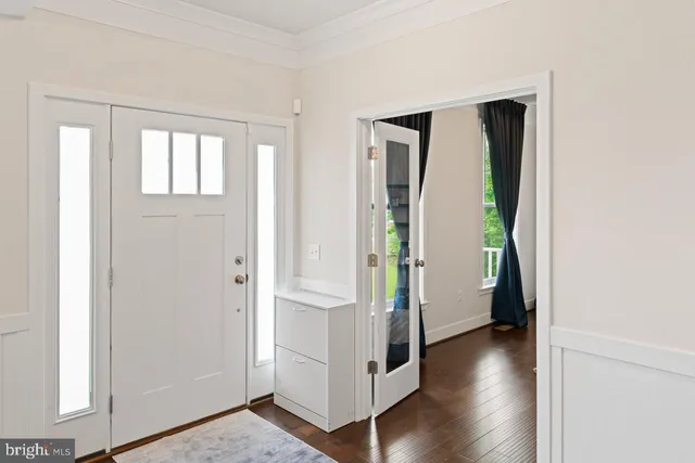 a view of an entryway with wooden floor