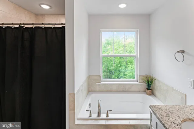 a bathroom with a sink double vanity granite and a mirror