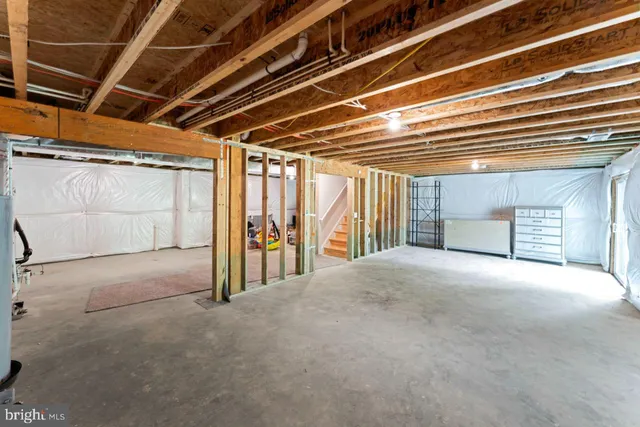 a view of a livingroom with an empty space and a window