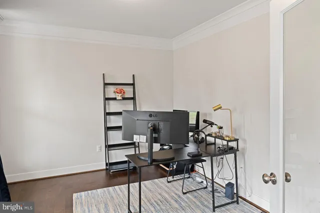 a view of a workspace with furniture and wooden floor