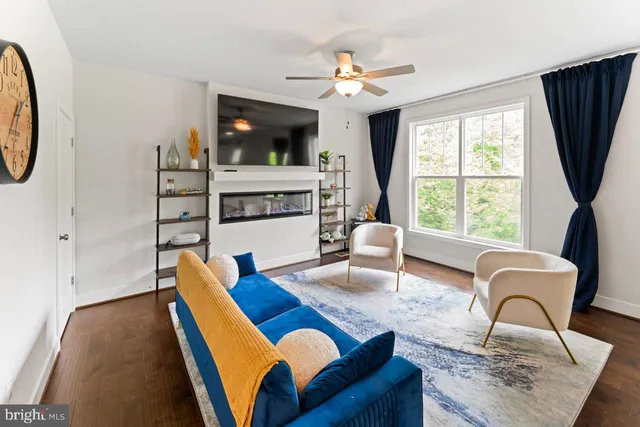 a living room with furniture fireplace and flat screen tv