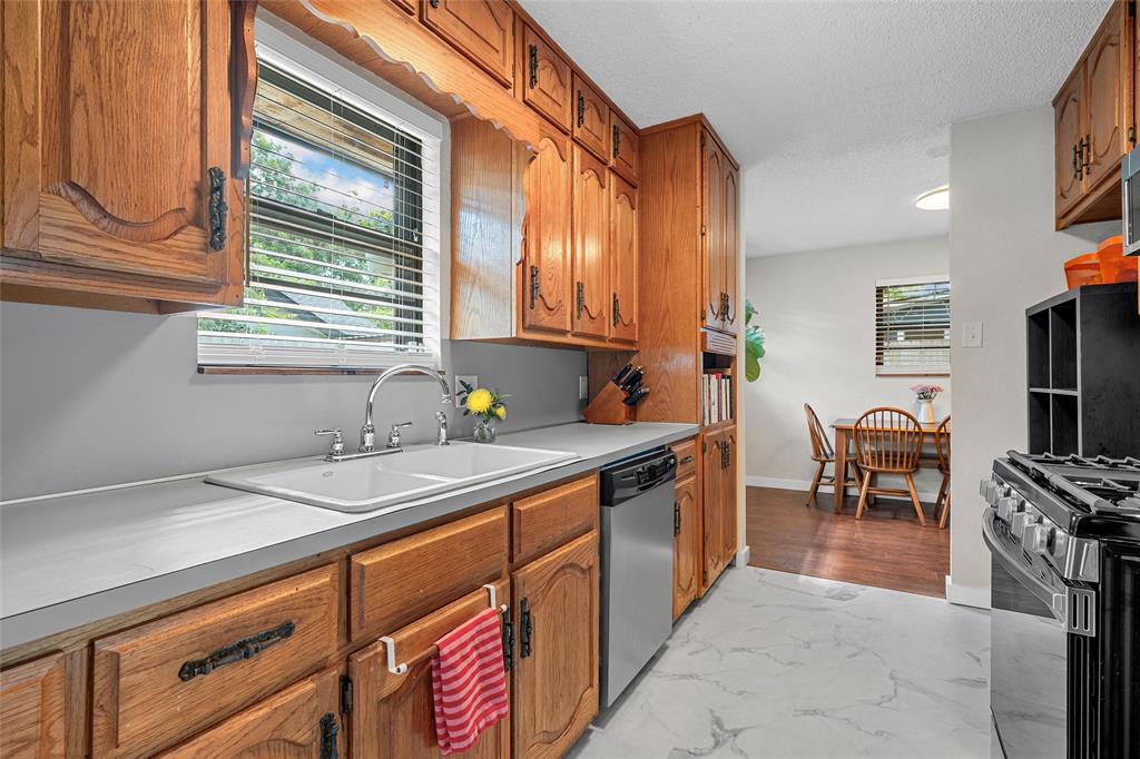 3000 North 15th A Street Waco, TX 76708 - Photo 9 of 24 a kitchen with granite countertop a sink and a stove