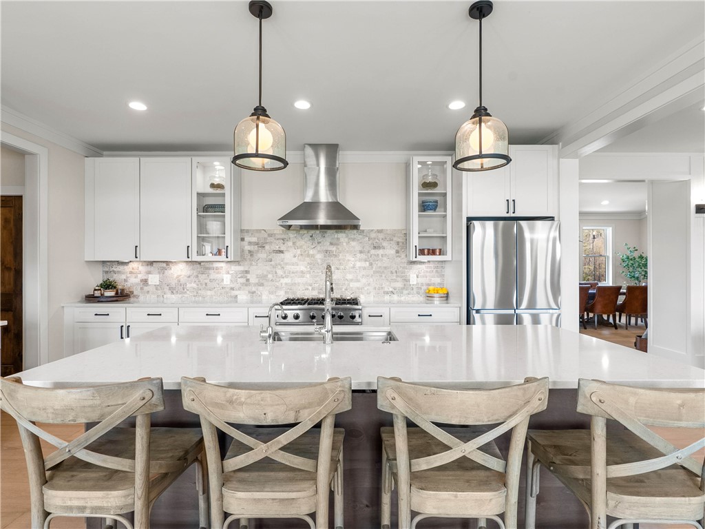 331 Bakerville Road Easley, SC 29642 - Photo 12 of 43 This kitchen features a spacious island, modern appliances, and elegant lighting for everyday living.
