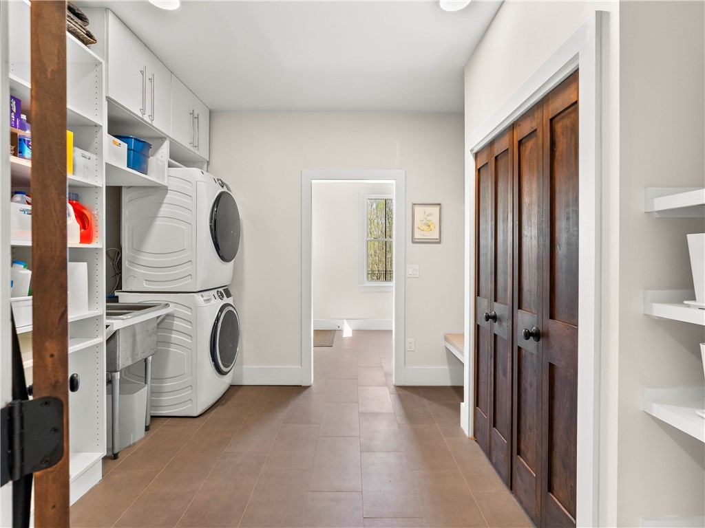 331 Bakerville Road Easley, SC 29642 - Photo 16 of 43 This spacious laundry room combines functionality with ample storage, offering a bright and organized space.