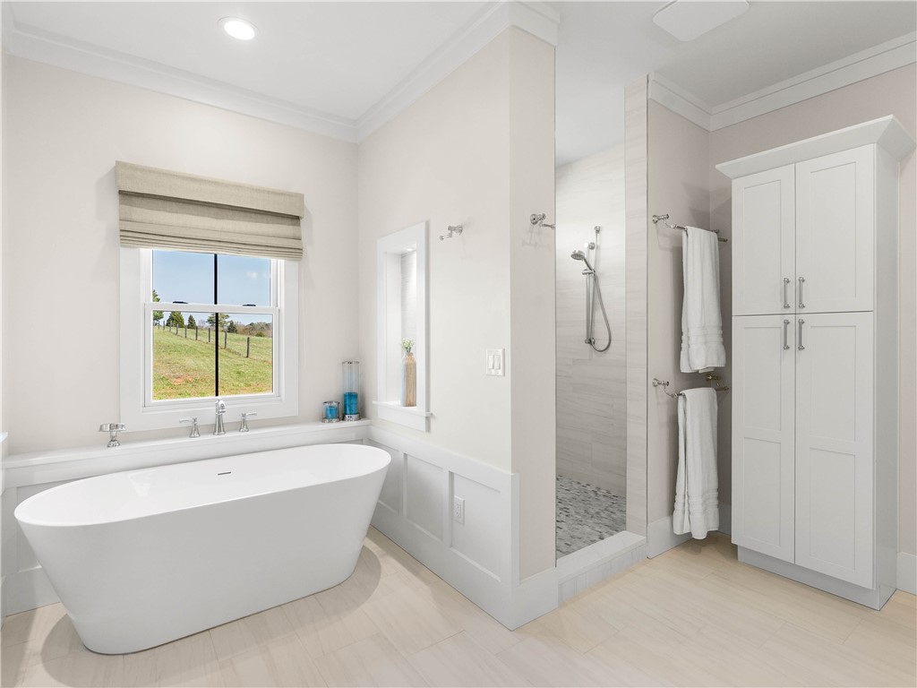 331 Bakerville Road Easley, SC 29642 - Photo 21 of 43 This serene bathroom offers a spa-like escape with a spacious soaking tub and expansive views.