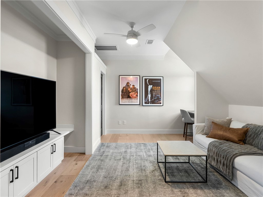 331 Bakerville Road Easley, SC 29642 - Photo 26 of 43 This bright living area features wood flooring and a classic ceiling fan, creating an inviting atmosphere.