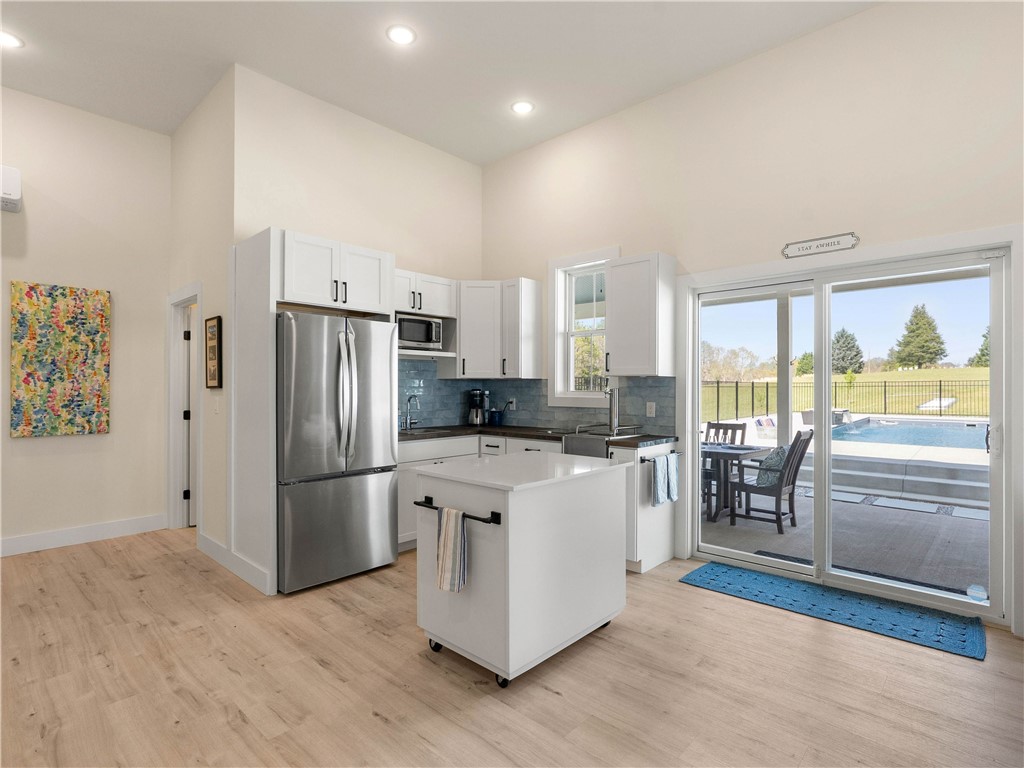 331 Bakerville Road Easley, SC 29642 - Photo 33 of 43 This modern kitchen features seamless outdoor access, perfect for entertaining or relaxing by the pool.