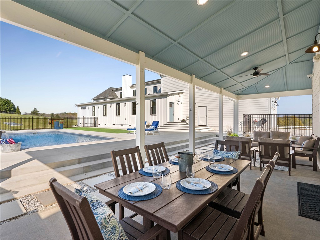 331 Bakerville Road Easley, SC 29642 - Photo 39 of 43 This spacious outdoor living area offers comfortable seating, a dining table, and direct pool access.