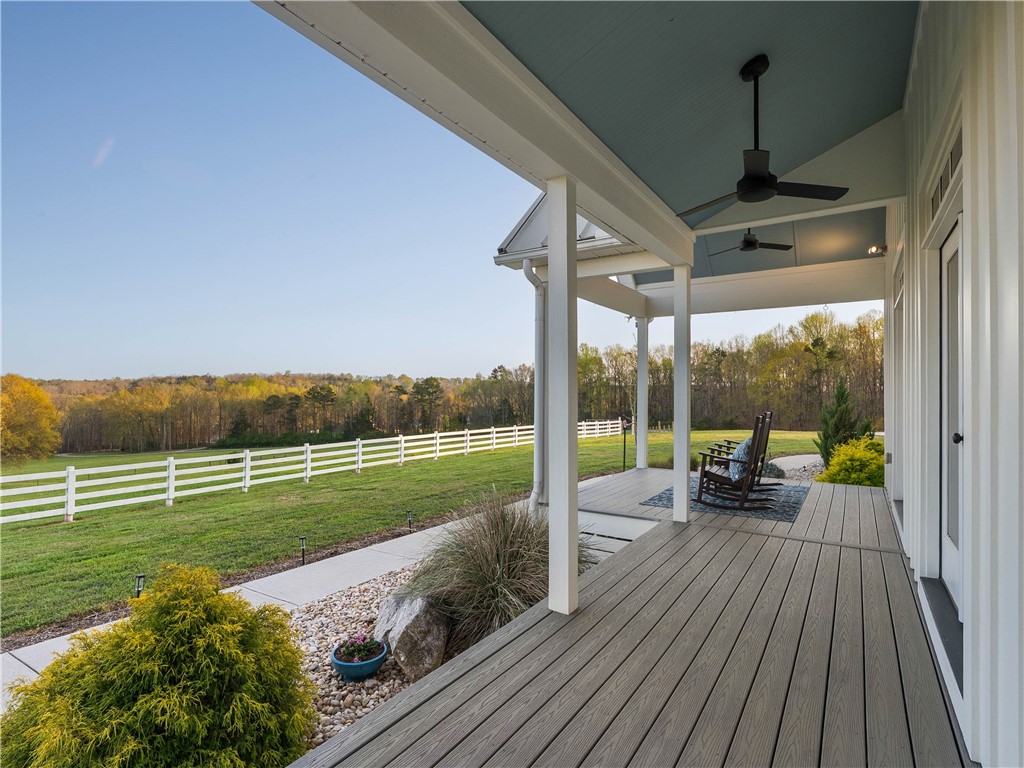 331 Bakerville Road Easley, SC 29642 - Photo 6 of 43 Relax on this spacious covered porch, embracing serene landscape views.