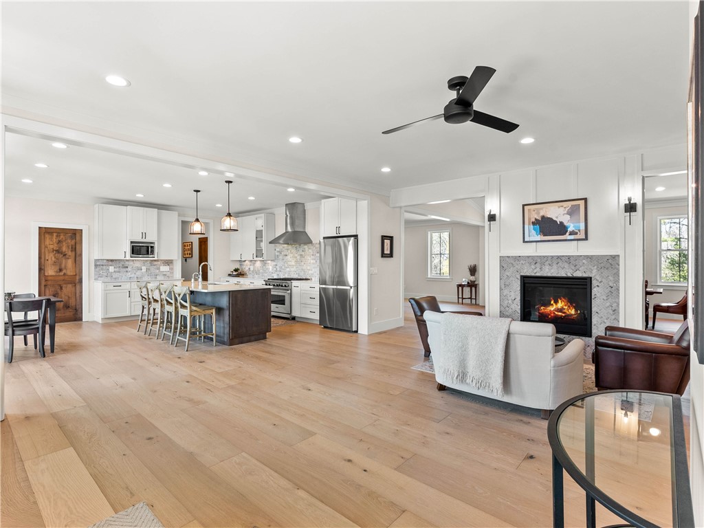 331 Bakerville Road Easley, SC 29642 - Photo 9 of 43 An inviting open-concept living space features a modern kitchen and a cozy fireplace.