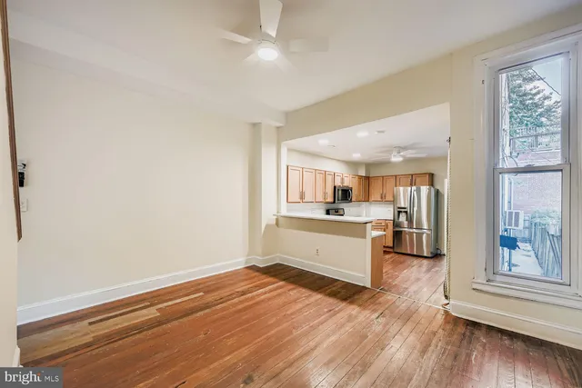 a view of a kitchen with wooden floor and a kitchen