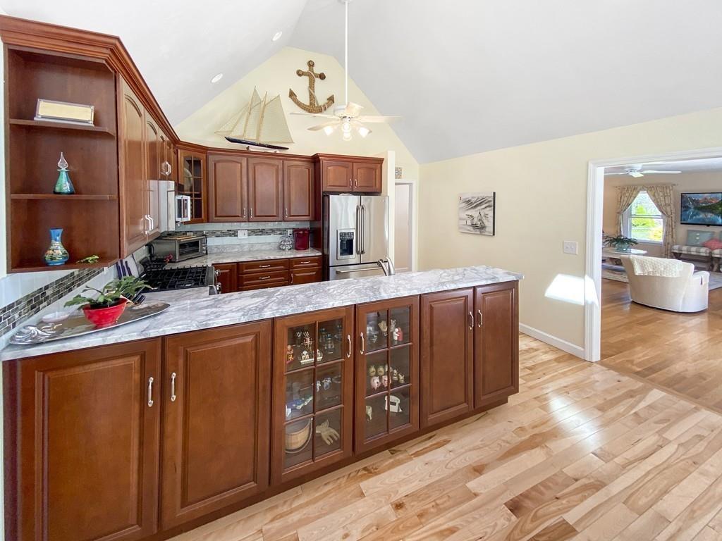 a kitchen with stainless steel appliances granite countertop a sink stove and cabinets