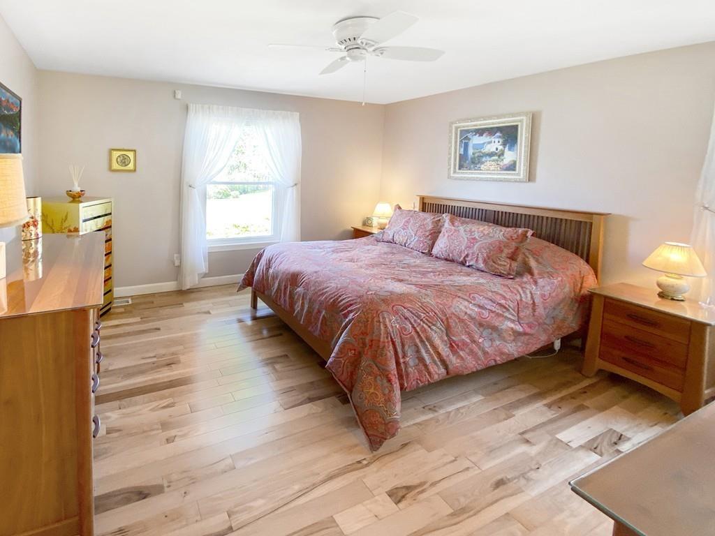 10 Weather Deck Road Bourne, MA 02532 - Photo 17 of 37 a bedroom with a bed and wooden floor