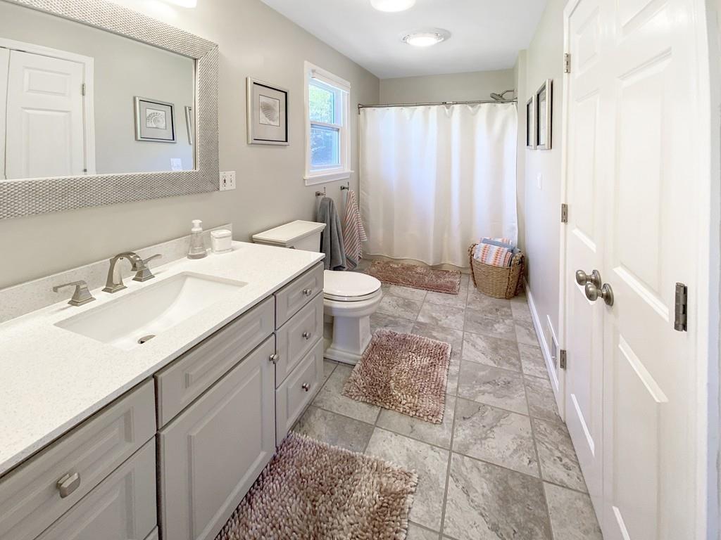 10 Weather Deck Road Bourne, MA 02532 - Photo 20 of 37 a spacious bathroom with a double vanity sink mirror and toilet