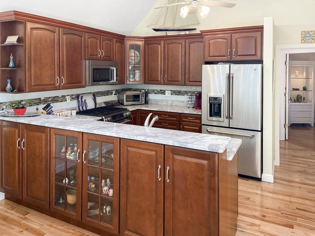 10 Weather Deck Road Bourne, MA 02532 - Photo 2 of 37 a kitchen with stainless steel appliances granite countertop a refrigerator stove top oven and sink