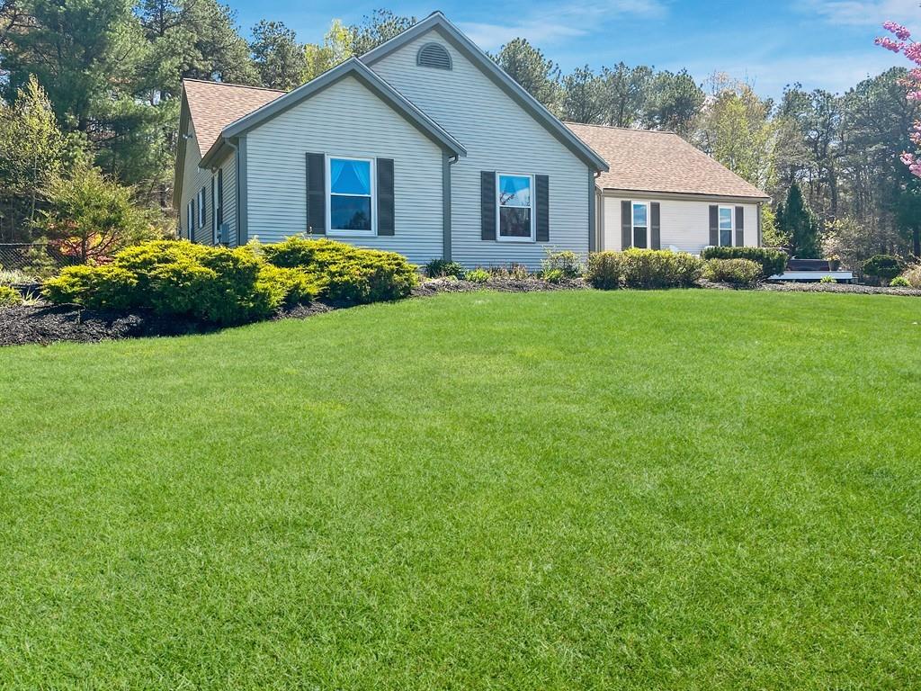 10 Weather Deck Road Bourne, MA 02532 - Photo 26 of 37 a front view of house with yard and green space