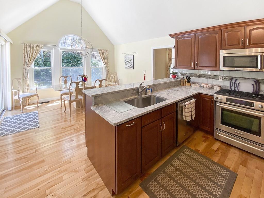 10 Weather Deck Road Bourne, MA 02532 - Photo 3 of 37 a kitchen with a sink stove and cabinets